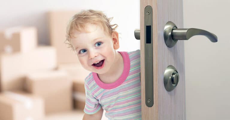 Happy child opening lever door