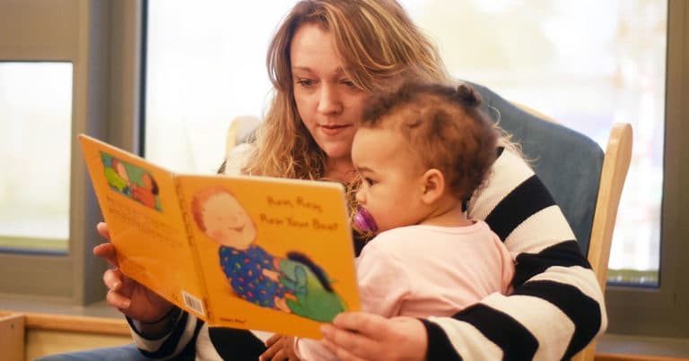 Mother reading to daughter