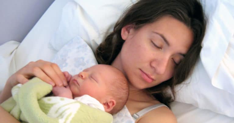 Mother sleeping with infant