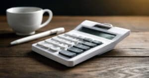 White calculator on wooden desk